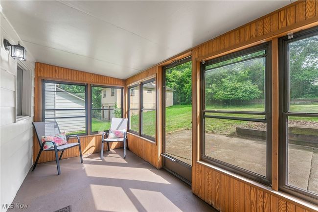 Sunroom / solarium featuring healthy amount of natural light and lofted ceiling | Image 5