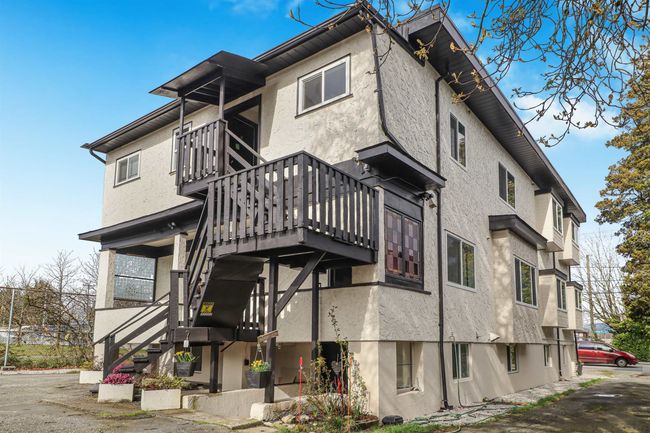 Rear view of house featuring stucco siding and stairway | Image 29