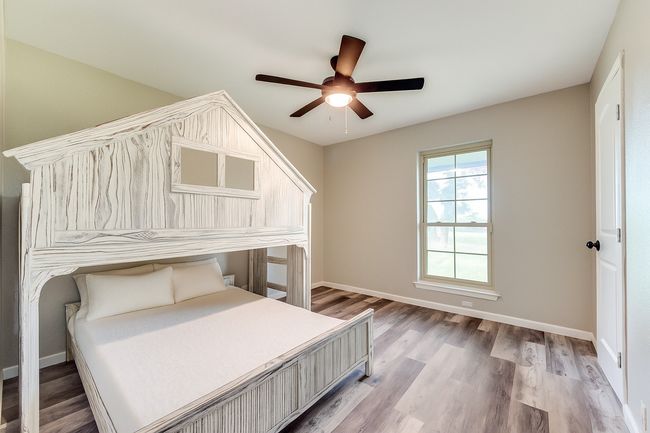 Bedroom with light wood-style floors and ceiling fan | Image 22