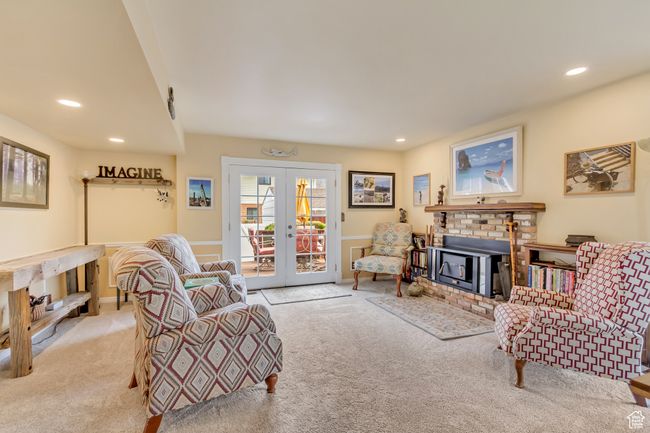 Living room featuring french doors, carpet flooring, recessed lighting, and a brick fireplace | Image 22
