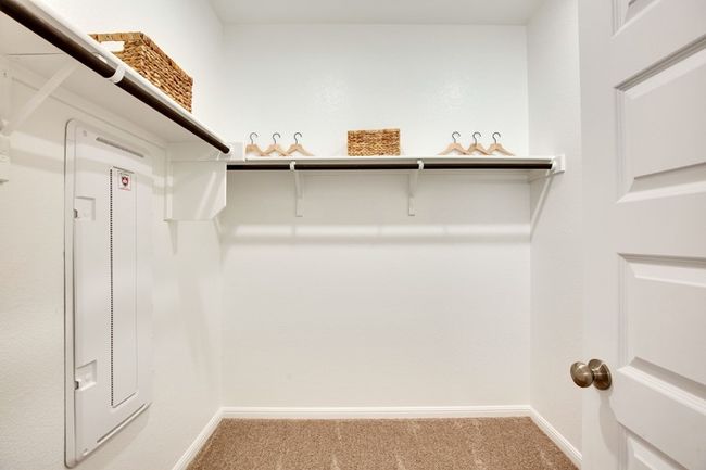 Walk in closet featuring light colored carpet | Image 7