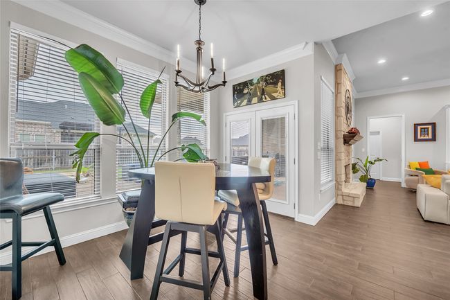 Dining area with ornamental molding, a chandelier, baseboards, dark wood finished floors, and recessed lighting | Image 15