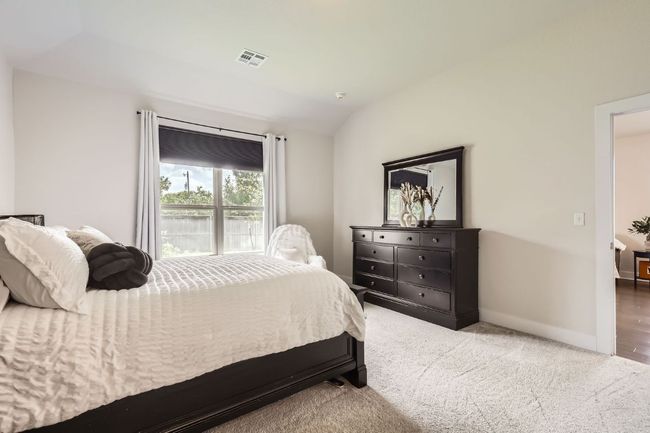 Carpeted bedroom with vaulted ceiling and baseboards | Image 14