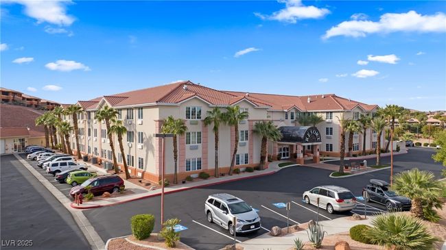 View of building exterior featuring a residential view and uncovered parking | Image 54