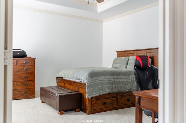 Carpeted bedroom with crown molding | Image 25
