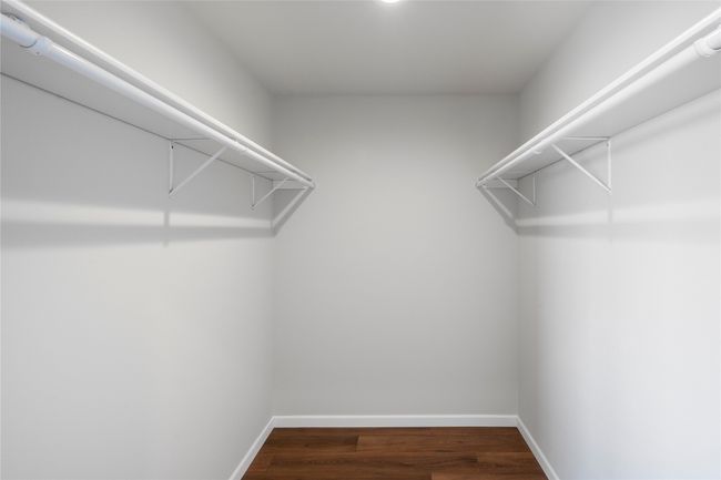 Walk in closet with dark wood-style floors | Image 47