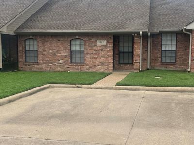 Ranch-style house featuring a patio area and a front lawn | Image 1