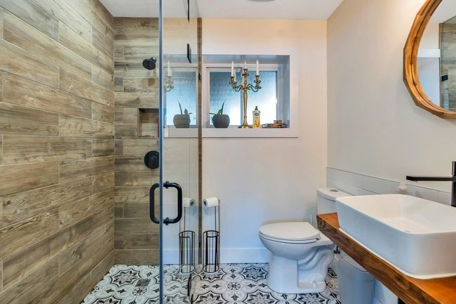 Full bathroom featuring toilet, a shower stall, tile patterned flooring, and a sink | Image 25