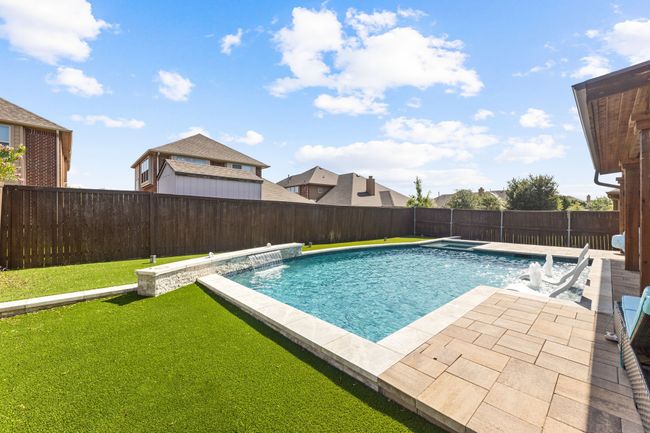 View of swimming pool featuring a fenced backyard, a yard, a patio, and a fenced in pool | Image 28