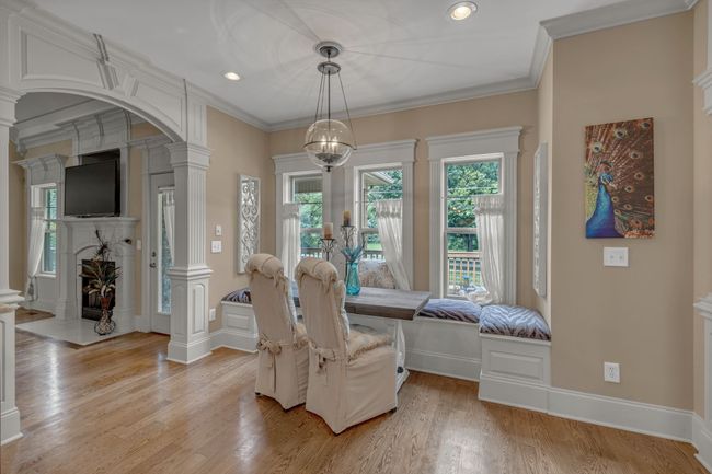 Eating area with bay windows and a window seat; perfect space for nature watching. | Image 21