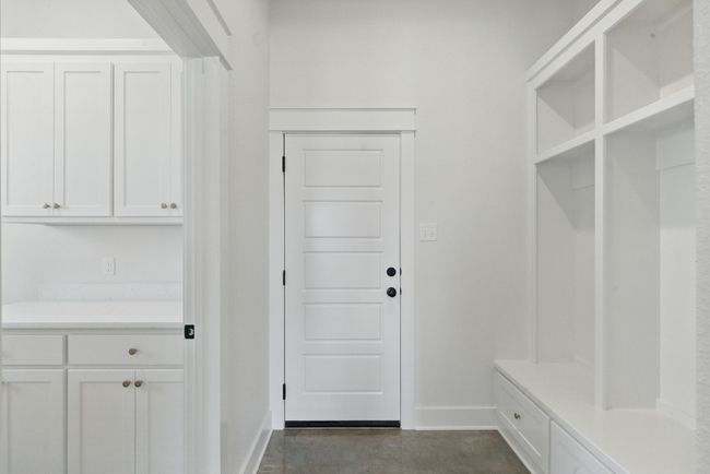 Mudroom featuring baseboards and concrete flooring | Image 22