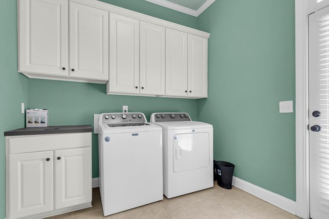 laundry room with cabinets | Image 47