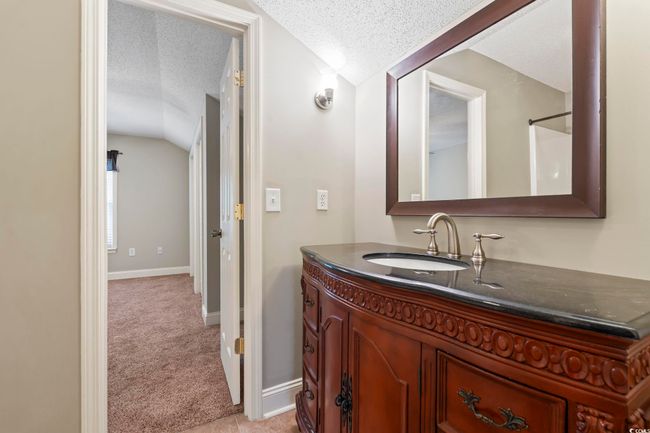 Bathroom with lofted ceiling, a textured ceiling, vanity, and baseboards | Image 28