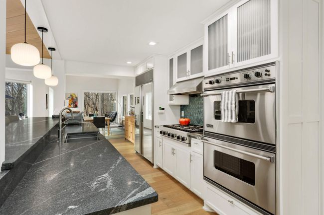 Luxury appliances including double oven, gas cooktop with range hood and built in refrigerator | Image 17