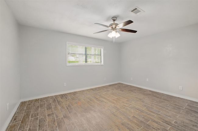 Retreat to the spacious primary suite featuring an ensuite bathroom, modern finishes, and a layout that invites rest and relaxation. | Image 19
