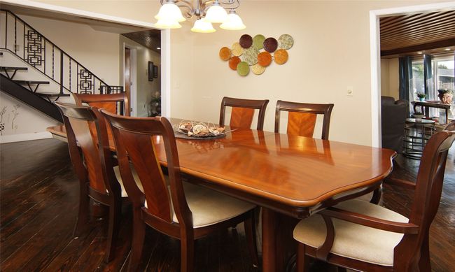 Separate dining room, yet open to the kitchen and great room via extra large doorways. Note the repeating unique iron work on the stairway! | Image 9