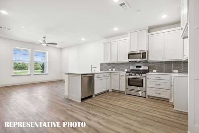 Light, bright and airy, this open concept kitchen-dining-family room is everything you have been searching for in a look and leave lifestyle home! REPRESENTATIVE PHOTO | Image 5