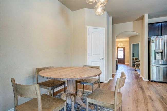 Dining space with arched walkways, baseboards, and light wood-type flooring | Image 18