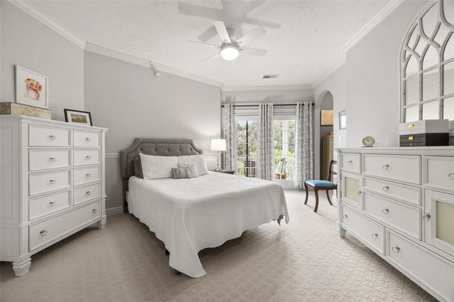 A ceiling fan light combo keeps the room bright and cool and notice the floor to ceiling windows overlooking the patio. | Image 21