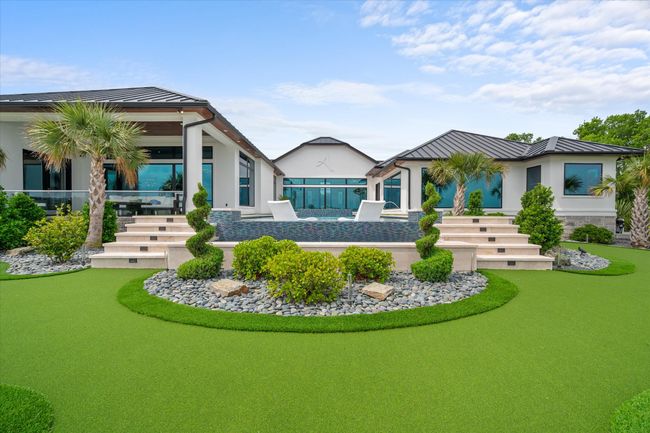 Back of property with stucco siding, metal roof, stairway, and a standing seam roof | Image 30
