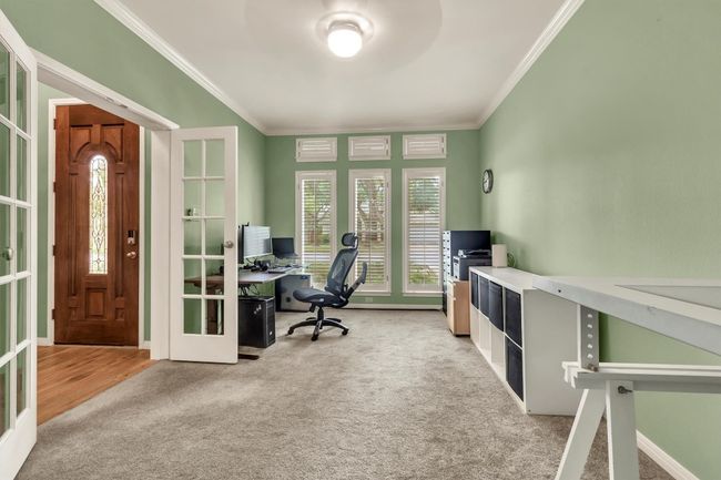 Office space featuring crown molding, french doors, and carpet | Image 8