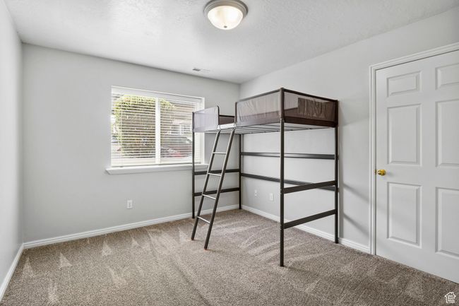 Unfurnished bedroom featuring carpet, baseboards, and a textured ceiling | Image 14