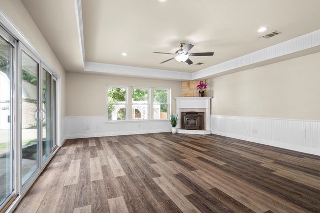 The large gameroom has a pellet stove, two walls of windows, and access to the patio. It is large enough for a gaming area and a pool table. | Image 30