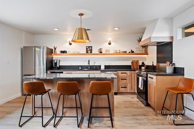 Kitchen with open shelves, appliances with stainless steel finishes, custom range hood, a center island, and recessed lighting | Image 34