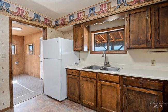 Kitchen featuring freestanding refrigerator, light countertops, and plenty of natural light | Image 15