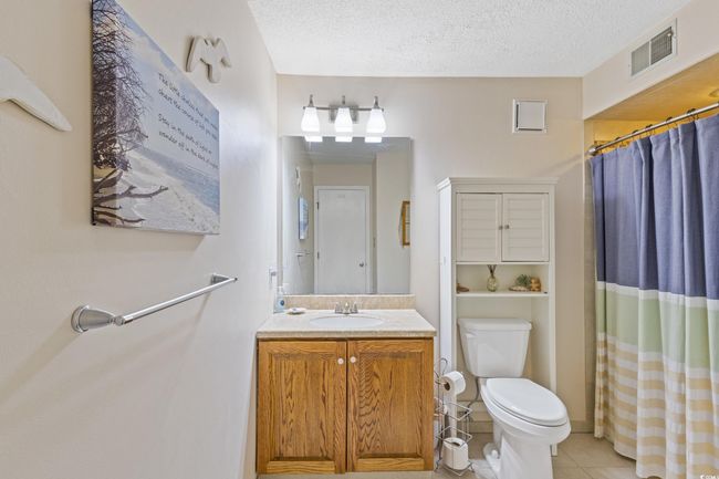 Bathroom featuring a textured ceiling, visible vents, tile patterned flooring, vanity, and​​‌​​​​‌​​‌‌​‌‌​​​‌‌​​‌‌​‌​​​​​‌ toilet | Image 22