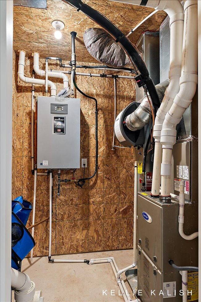 On-demand water heater and furnace in utility closet in Garage. Convenient access without having to enter the home. | Image 32