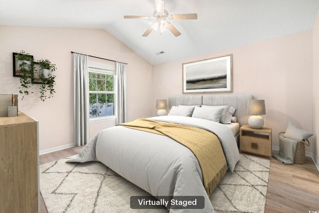 Bedroom with light wood-type flooring, lofted ceiling, and ceiling fan | Image 5