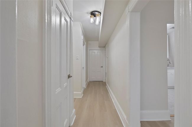 Hall with light wood-style floors and baseboards | Image 6