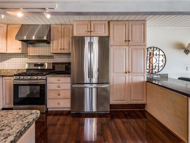 Bar area for seating at the kitchen, while still part of the rest of the living space. | Image 13
