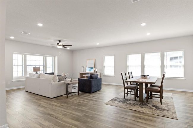 Dining area featuring ceiling fan, wood finished floors, and recessed lighting | Image 11