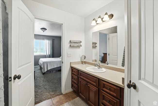 Bathroom with connected bathroom, vanity, and tile patterned flooring | Image 21