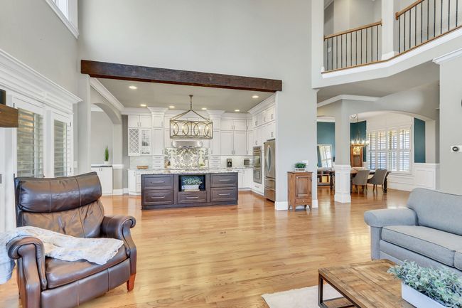 A true, open concept floor plan. The exposed wood beam marks the kitchen space. | Image 14