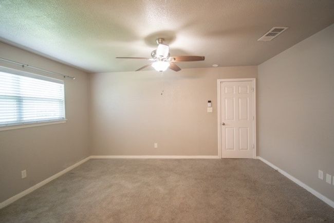 Empty room featuring a ceiling fan, carpet, baseboards, and a textured ceiling | Image 8