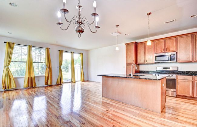 Open floor plan with hardwood flooring | Image 6