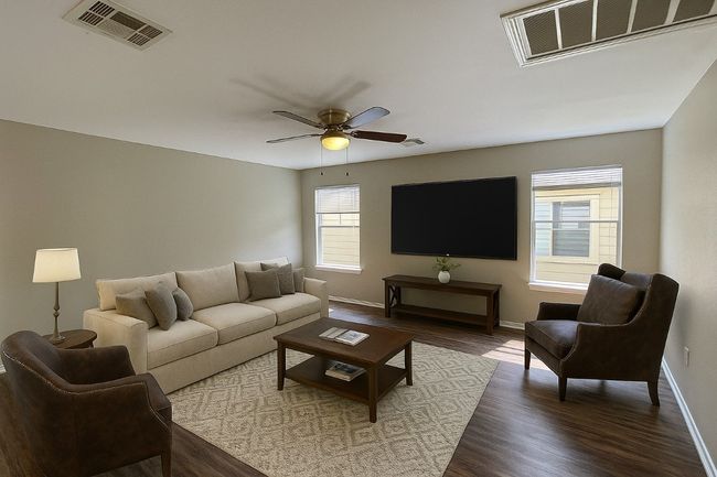 Living room with dark wood-style floors and a ceiling fan | Image 9
