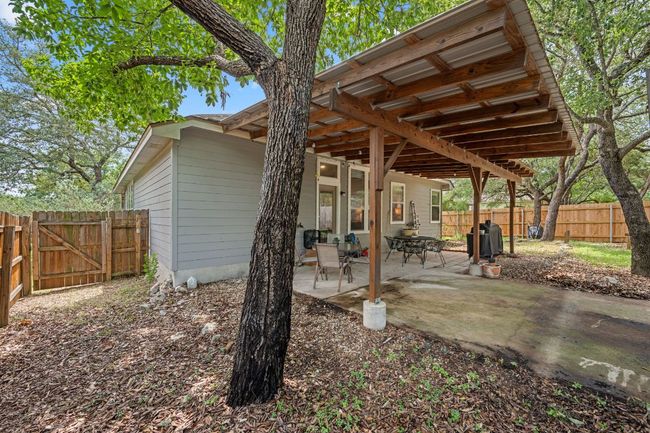Fenced backyard with a patio area and a gate | Image 28