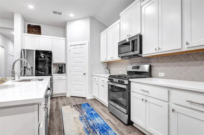 Quartz countertops with farmhouse sink. | Image 22