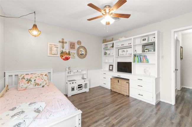 Bedroom featuring dark wood-type flooring, baseboards, and ceiling fan | Image 23
