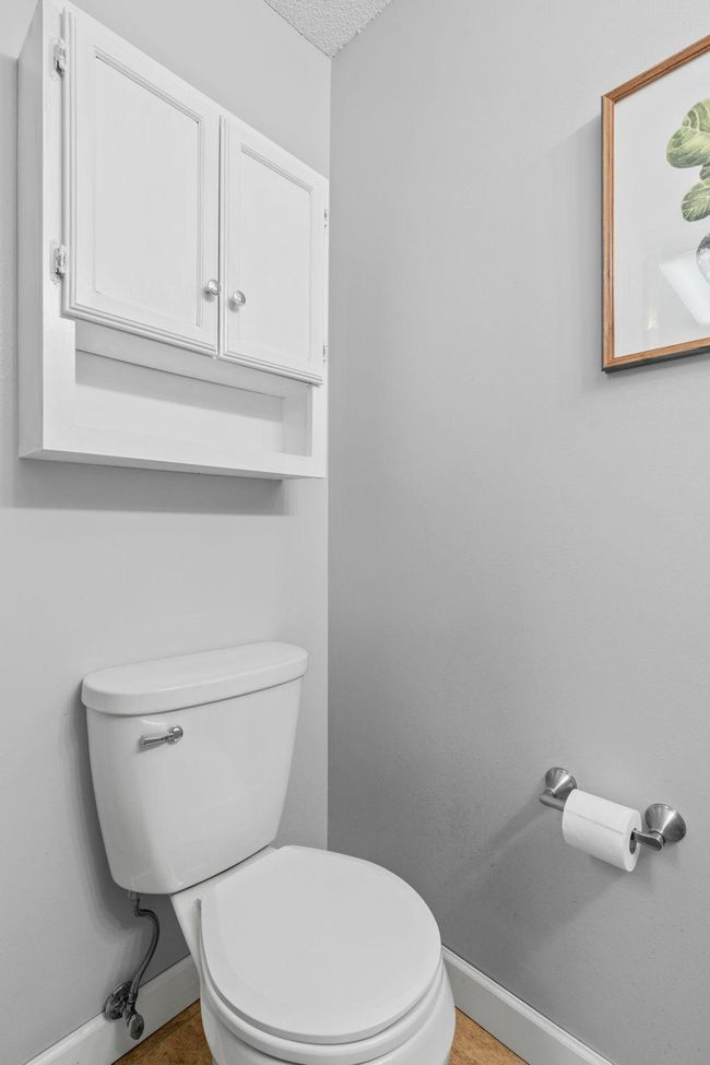 Main-level powder room with additional cabinet storage for toiletries and essentials. | Image 13