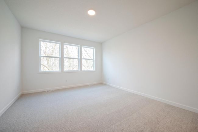 Photo of actual home. The spacious primary suite is full of gorgeous natural light from the large windows! | Image 6