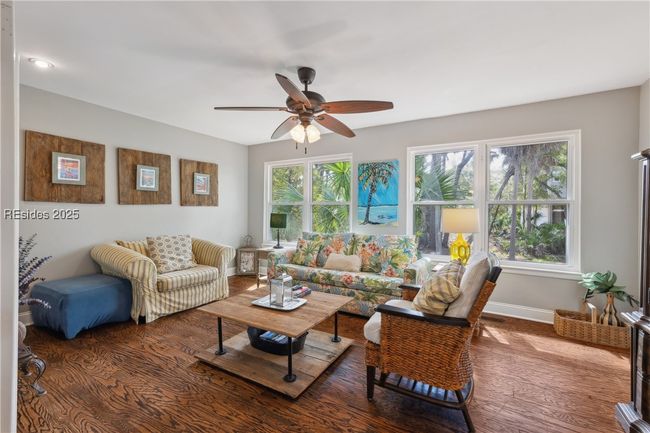 Second living room with plenty of lounging areas, gorgeous open windows allow for plenty of natural light if desired, hardwood floors. | Image 39