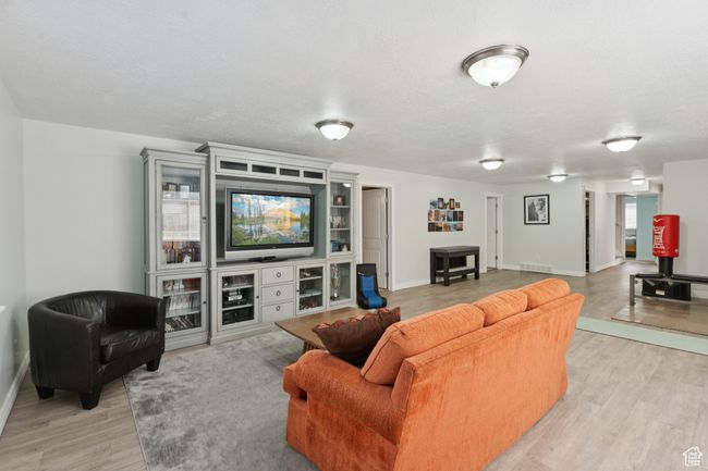 Living area featuring light wood-style flooring and baseboards | Image 25