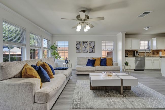 Living room with light hardwood / wood-style floors, ornamental molding, and ceiling fan | Image 18