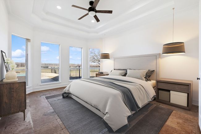 Bedroom featuring stone tile flooring, multiple windows, a raised ceiling, recessed lighting, and ornamental molding | Image 16