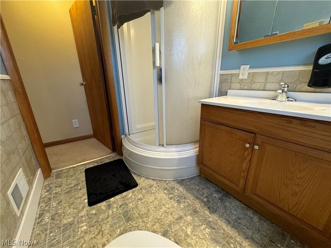 Bathroom with tile flooring, backsplash, and vanity | Image 26